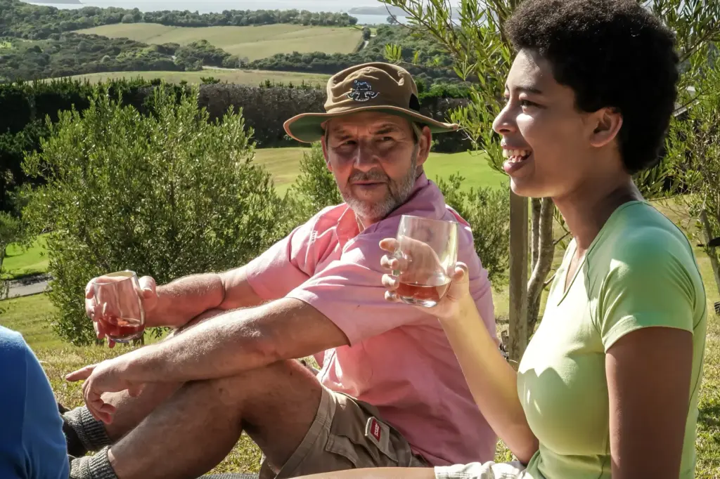 Guests enjoying a glass of wine in the vineyard at Mudbrick on a private Waiheke walk