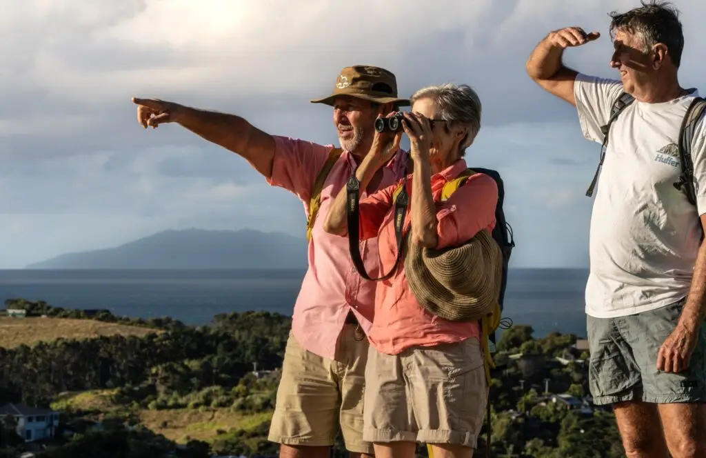 Guests enjoying the view from the Mudbrick trig on one of Terra & Tide's guided walking tours on Waiheke Island