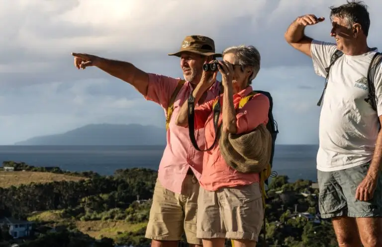 Guests enjoying the view from the Mudbrick trig on one of Terra & Tide's guided walking tours on Waiheke Island