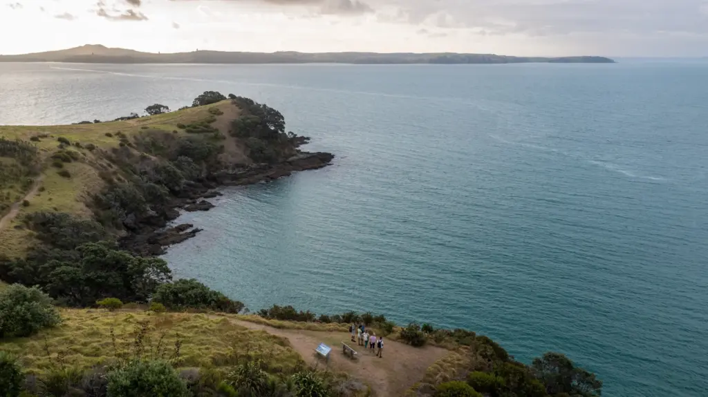 Small group walking the Matiatia headland on the Double Headland Walk, Waiheke Island