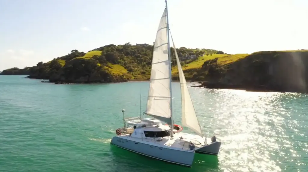 Terra & Tide catamaran Pacific Star sailing in a sunlit Waiheke Island bay