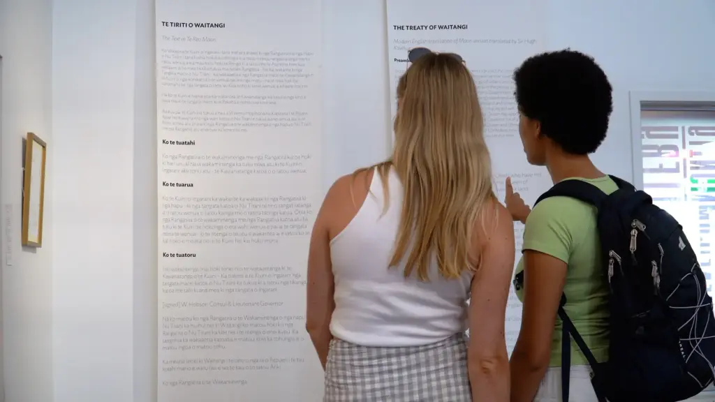 Guests viewing the Te Tiriti o Waitangi exhibition on Waiheke Island