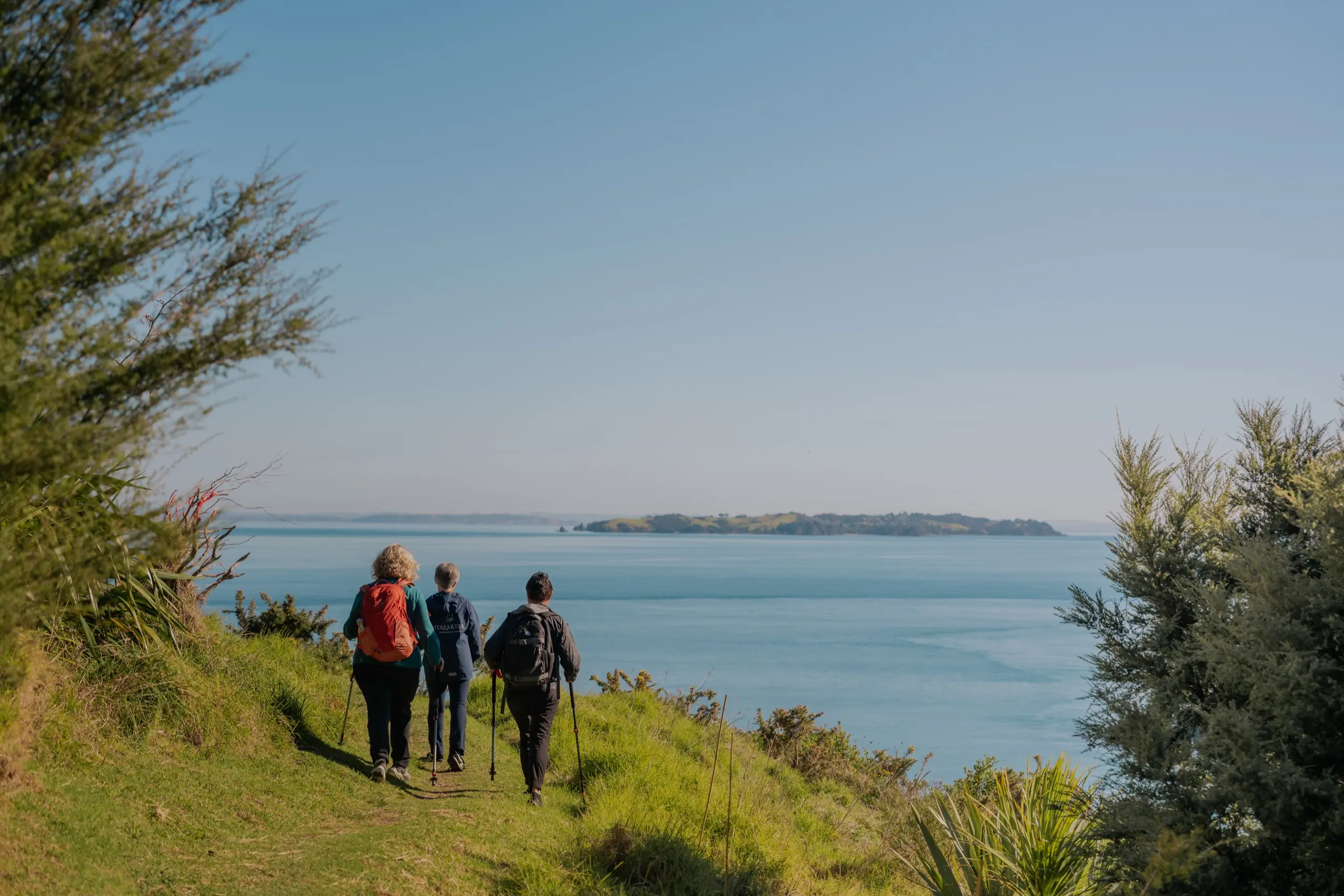 Guided walking group on a coastal track on Waiheke Island