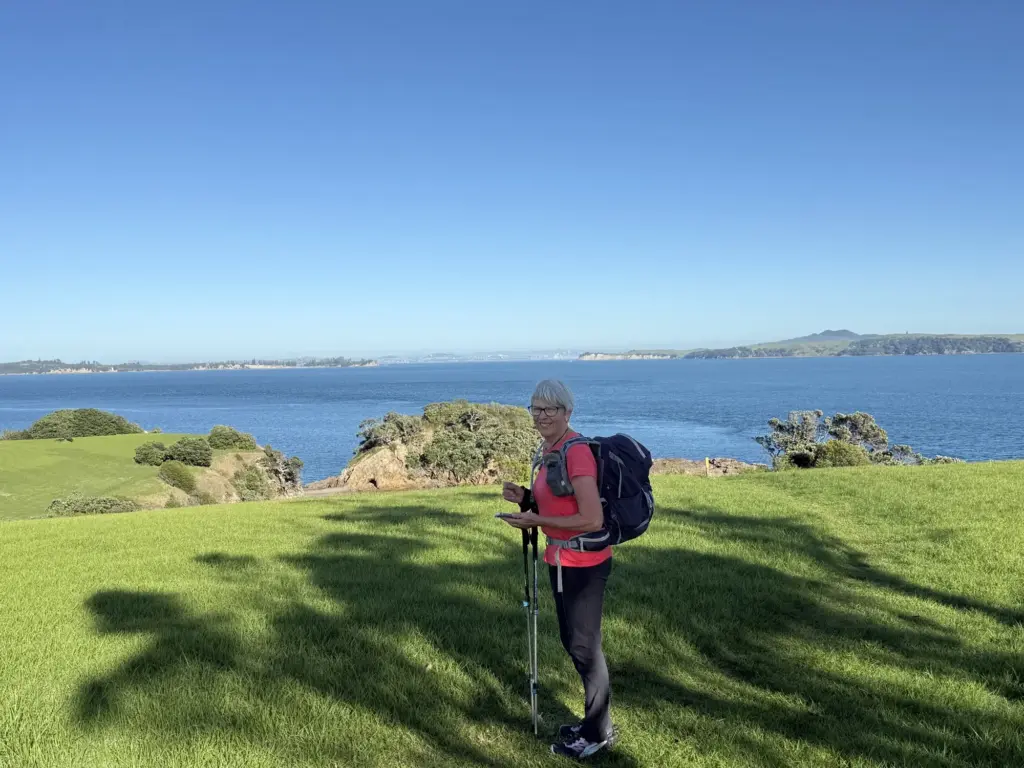 Walker looking back to the Auckland city skyline from Waiheke Island