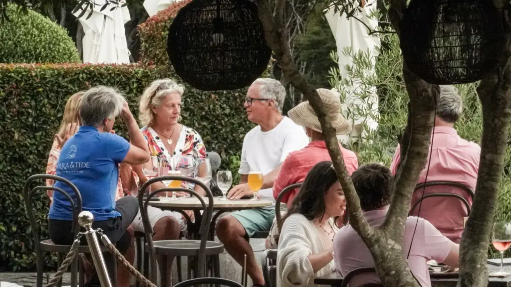 Guests at a wine tasting in the garden at Mudbrick, Waiheke Island